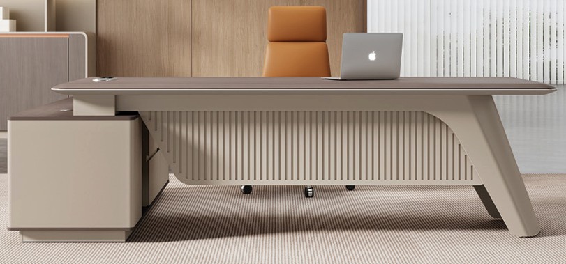 Large grey executive desk with slatted front panel and side pedestal cabinet in a modern office setting