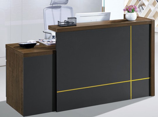 Dark charcoal reception desk with gold accent lines and integrated storage cabinet